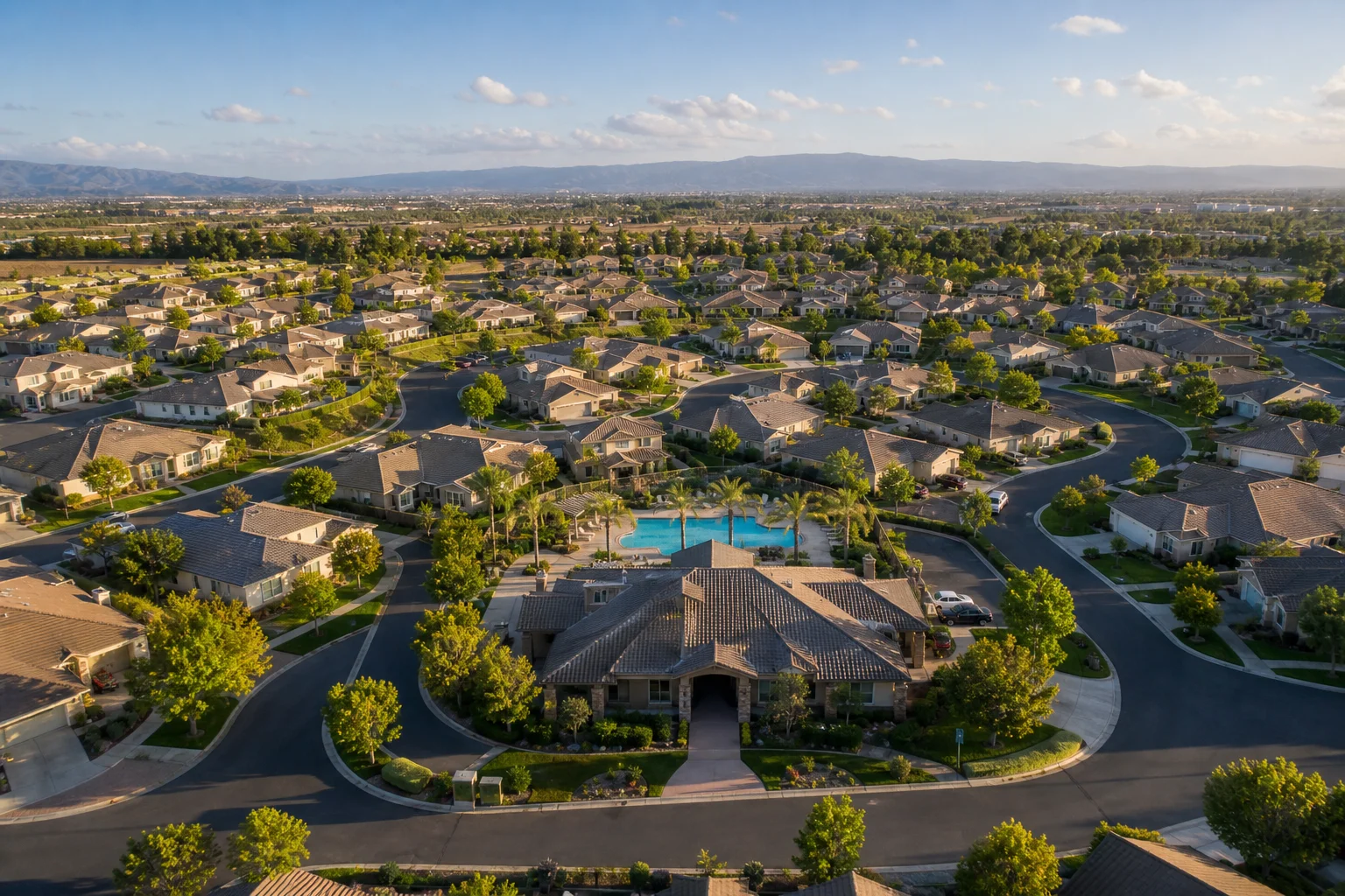 Aerial view of HOA residential community showing uniform homes arranged around a central clubhouse, illustrating the scale that requires dedicated HOA bookkeeping software
