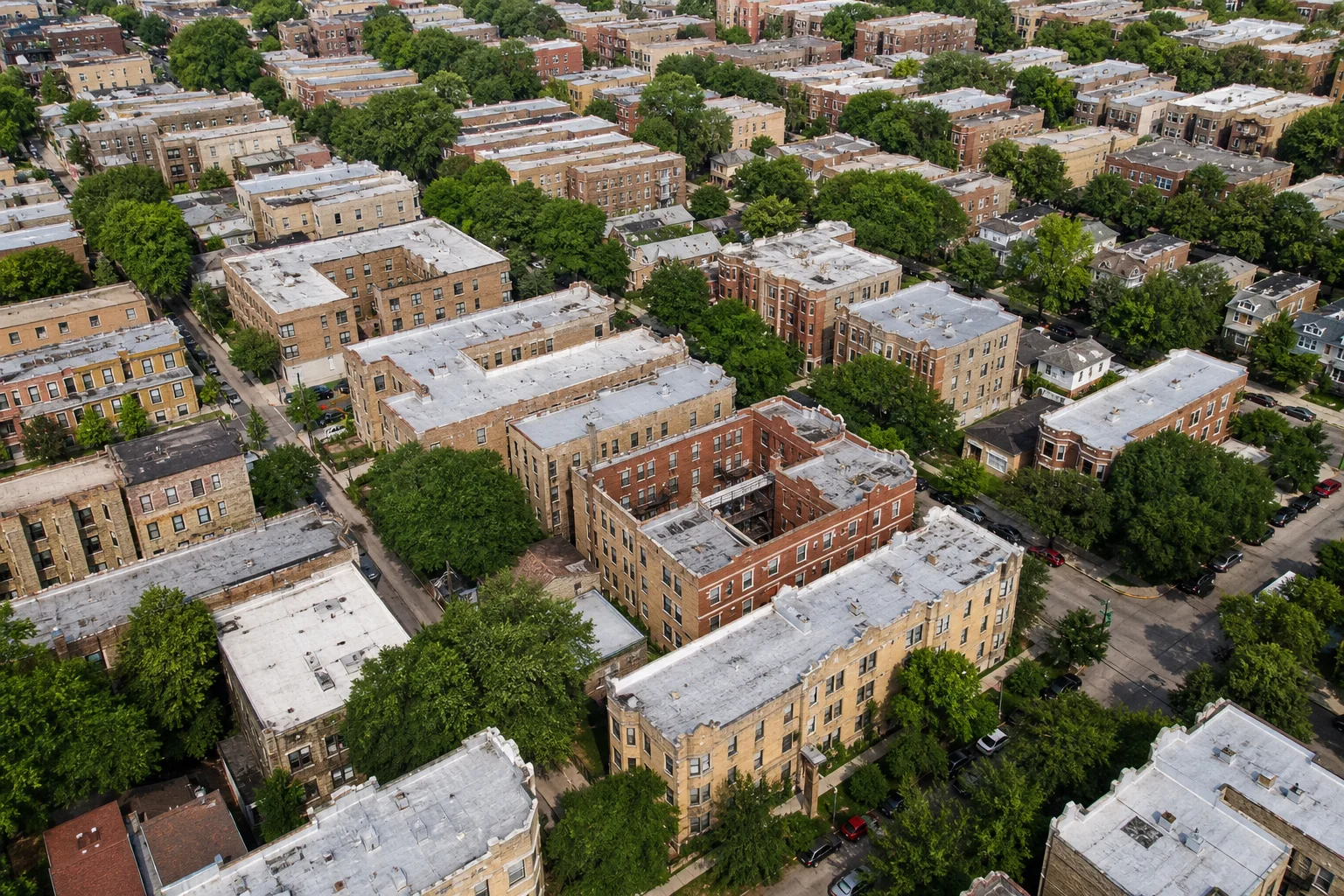 Aerial view of Chicago multifamily apartment buildings and tree-lined residential streets representing outsourced accounting for property management companies in Chicago